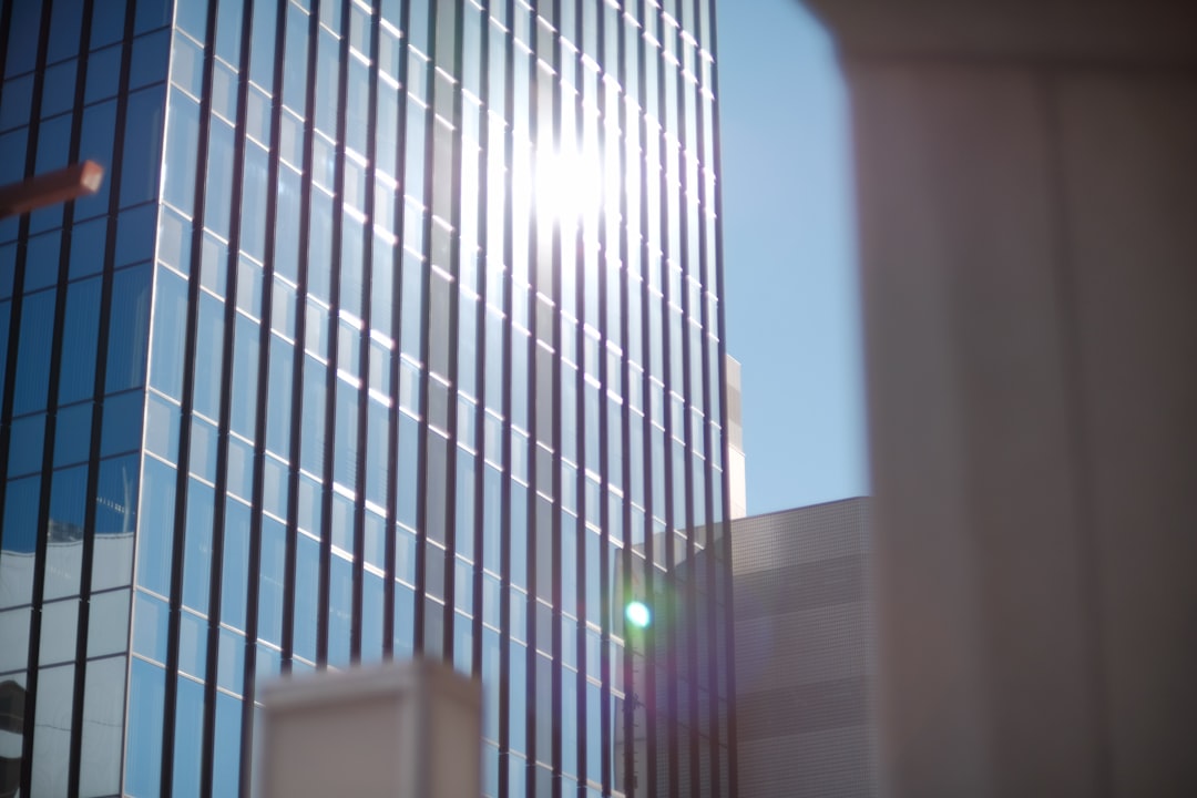 the sun shines brightly through the windows of a tall building