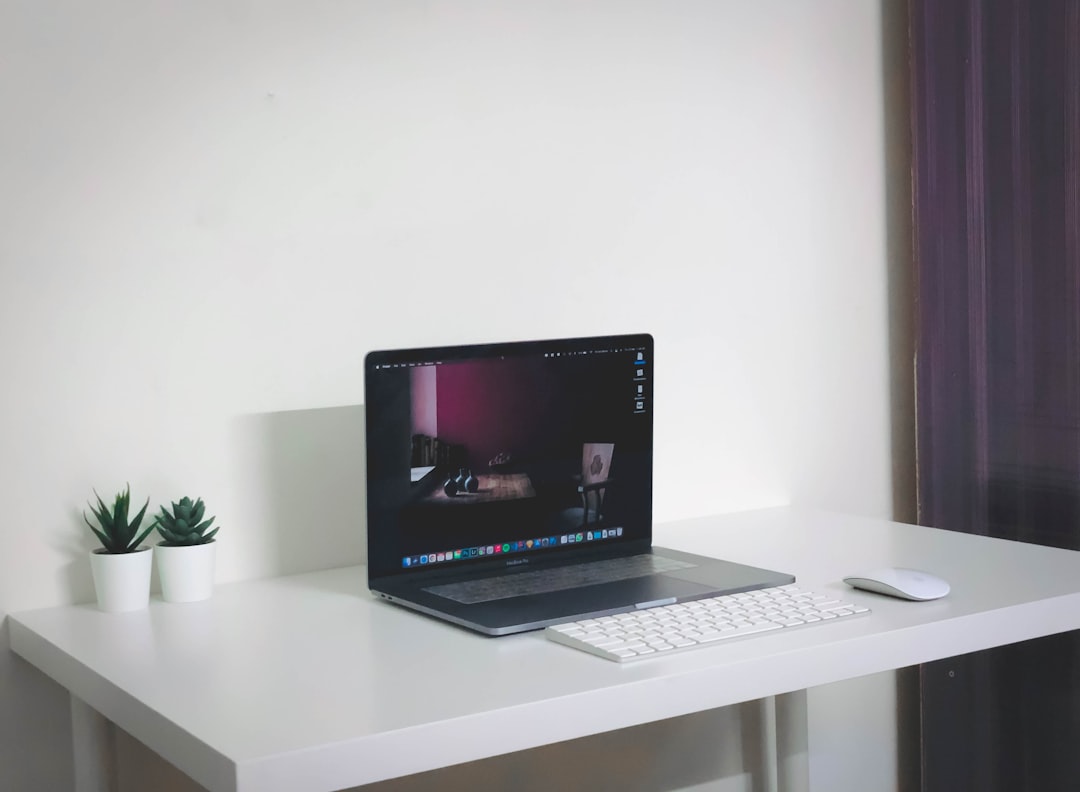 black laptop computer on white table