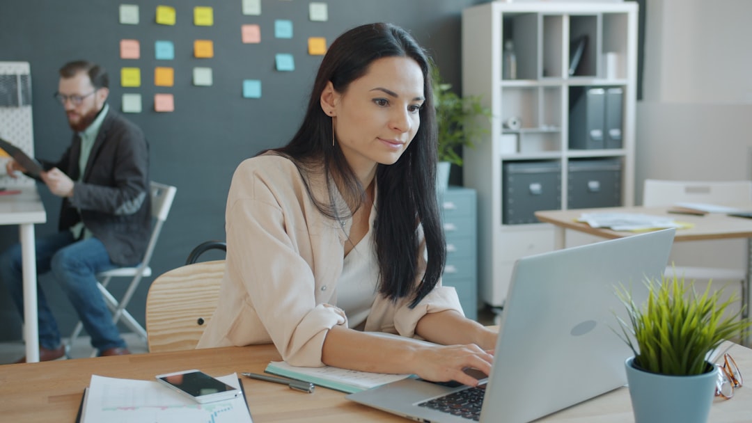 Woman working on laptop in a modern office