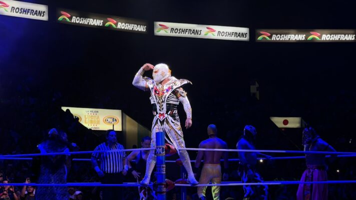 A man standing on top of a wrestling ring
