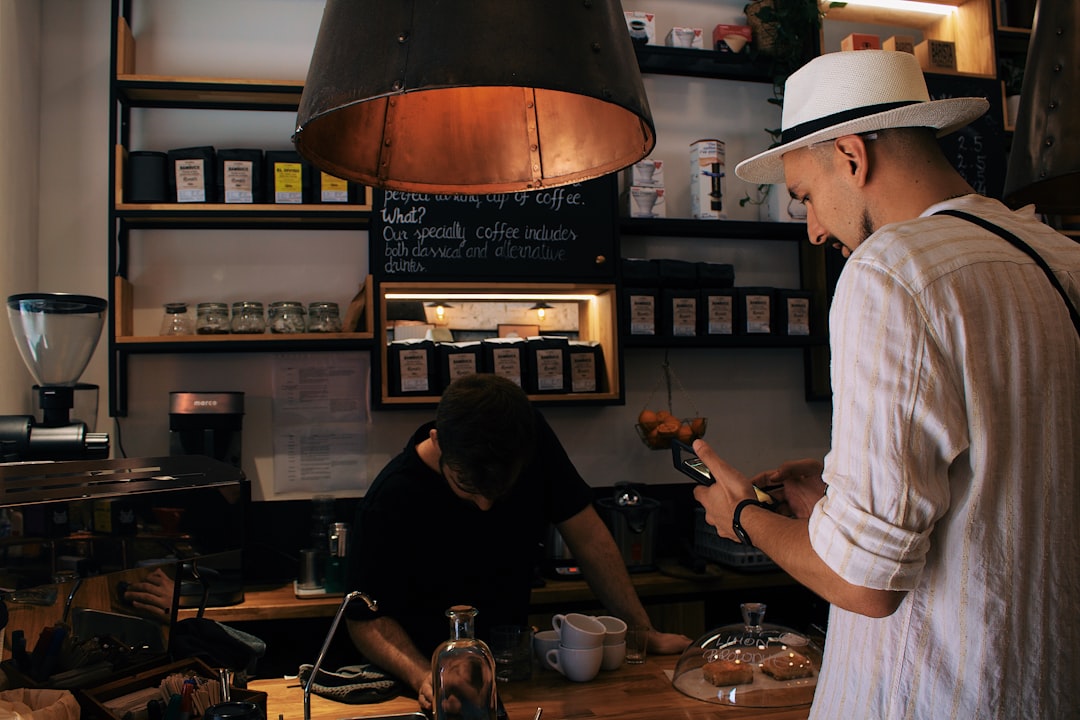 man holding phone standing in front of man