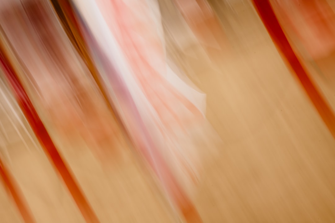 Abstract streaks of red and white on beige background