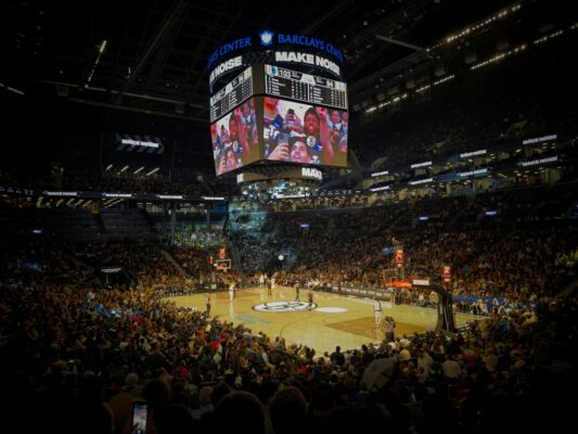 A crowd of people watching a basketball game
