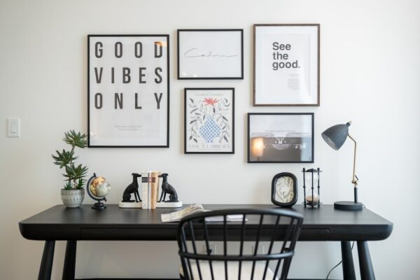 Desk with framed art and office supplies