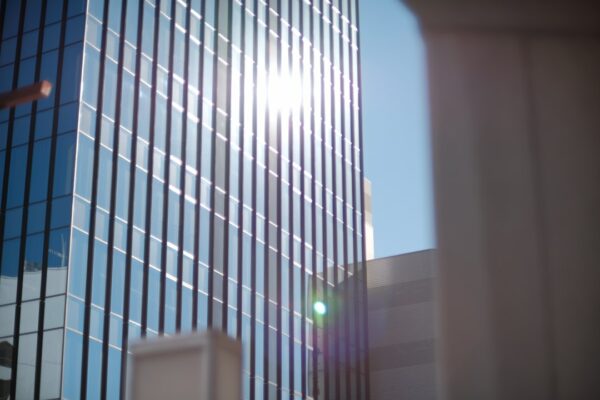the sun shines brightly through the windows of a tall building