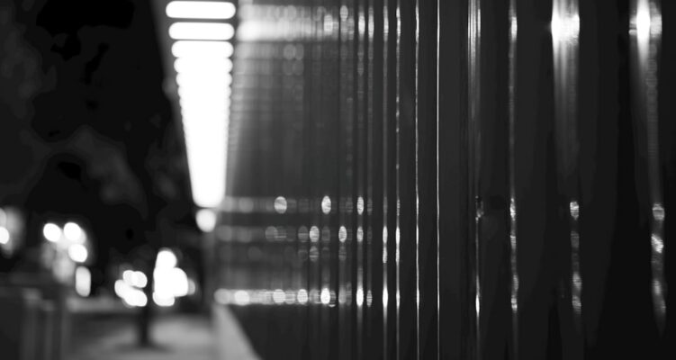 Abstract black and white vertical lines with bokeh effect.