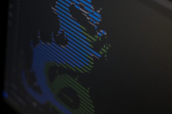 A close up of a computer screen with a blurry image of a person